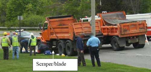 Arrow pointing to scraper/blade on one of the trucks