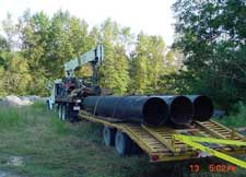 Sections of pipe on the truck trailer into which the steel augers were to be inserted.