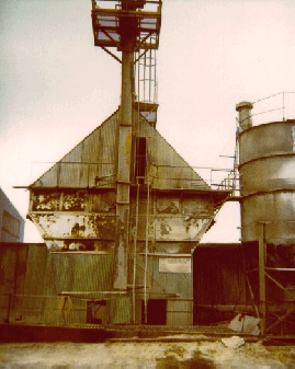 A photograph of the back of the plant, with a ladder leading to the door of the change-over room.