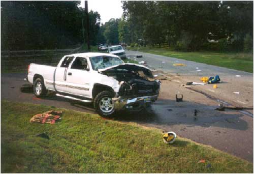 Photo 3. Illustrates damage to the passenger’s side of the vehicle.