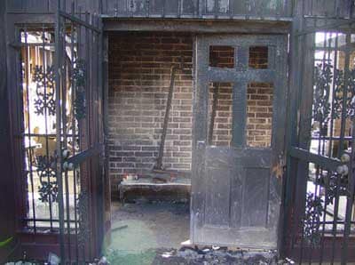 Photo 1. Illustrates the front door (side-A) and the burglar bars restricting entry.