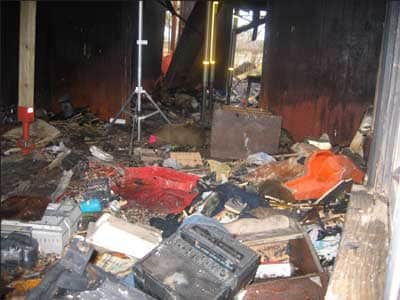 Photo 1. Note cluttered condition of floor in living room.
