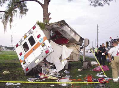 Photo 3. Patient compartment of ambulance after crash, showing the separation of curbside wall and roof.