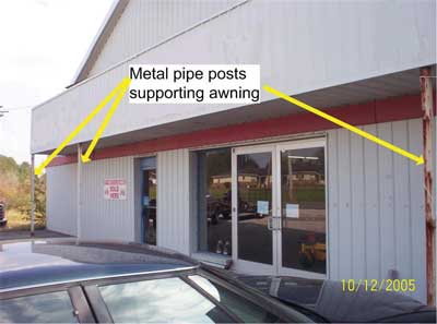 A-side of structure taken four months prior to incident. Note overhanging awning over entranceway; metal pipe posts supporting front of awning.