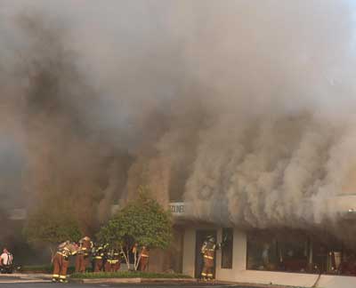 Smoke rolling out of a commercial building