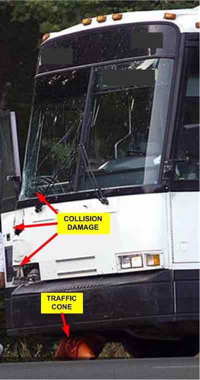 collision damage on bus and traffic cone under bus