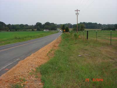 stretch of road where the accident occurred and fresh dirt on the shoulder