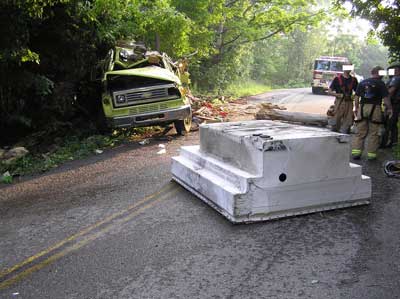 Water tank removed from truck and laying in the middle of the road
