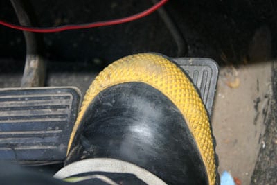 Close up of Boot of Fire Fighter applied to gas pedal and stuck under the brake pedal