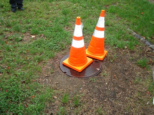 safety cones on manhole cover