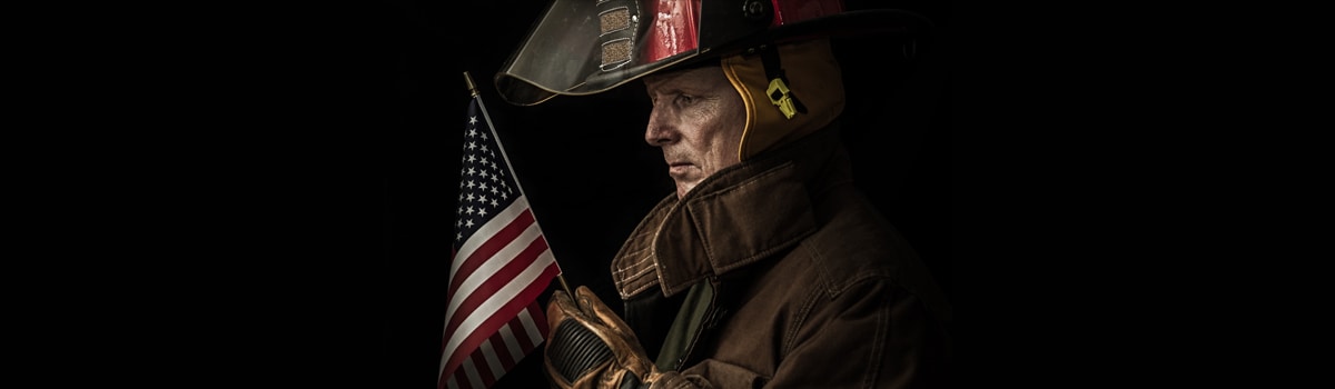 firefighter holding an American Flag