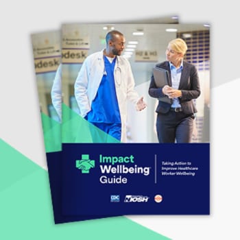 Cover of the Impact Wellbeing Guide, which has an African American physician speaking to a listening white female executive as they walk down a hallway. 