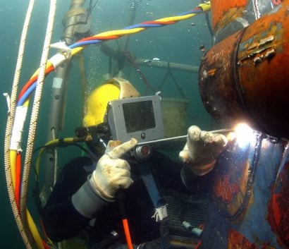 Commercial diver welding under water.