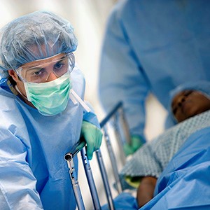 Healthcare providers putting up bed rails.