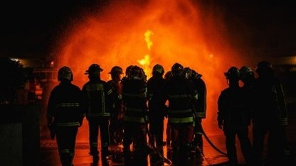 firefighters in front of a blaze