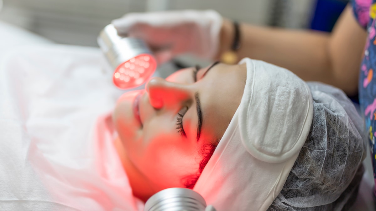 Woman undergoing infrared light therapy facial treatment