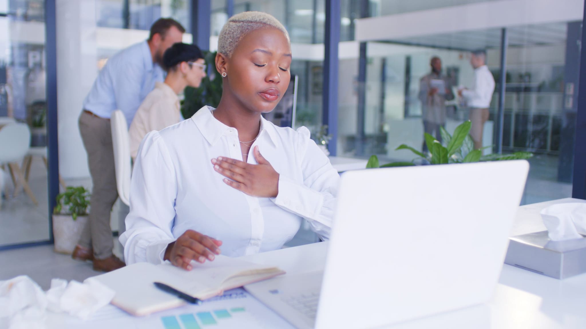 African American woman experiencing chest pain at work.
