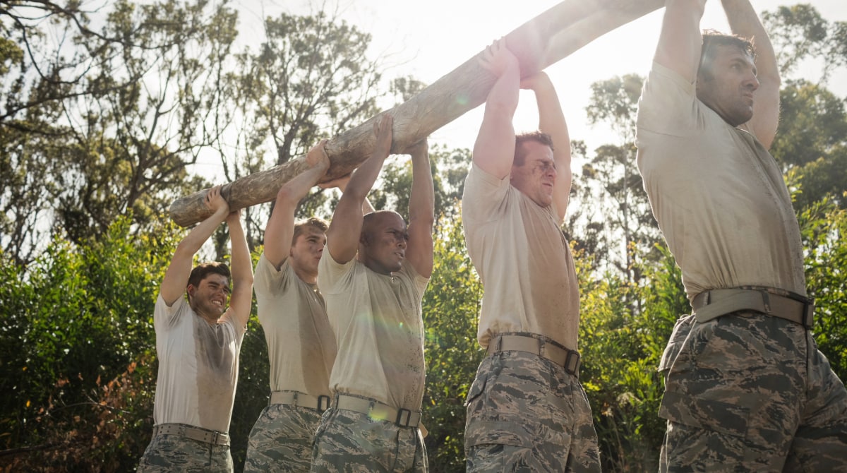 Military personnel exercising outside, sweating