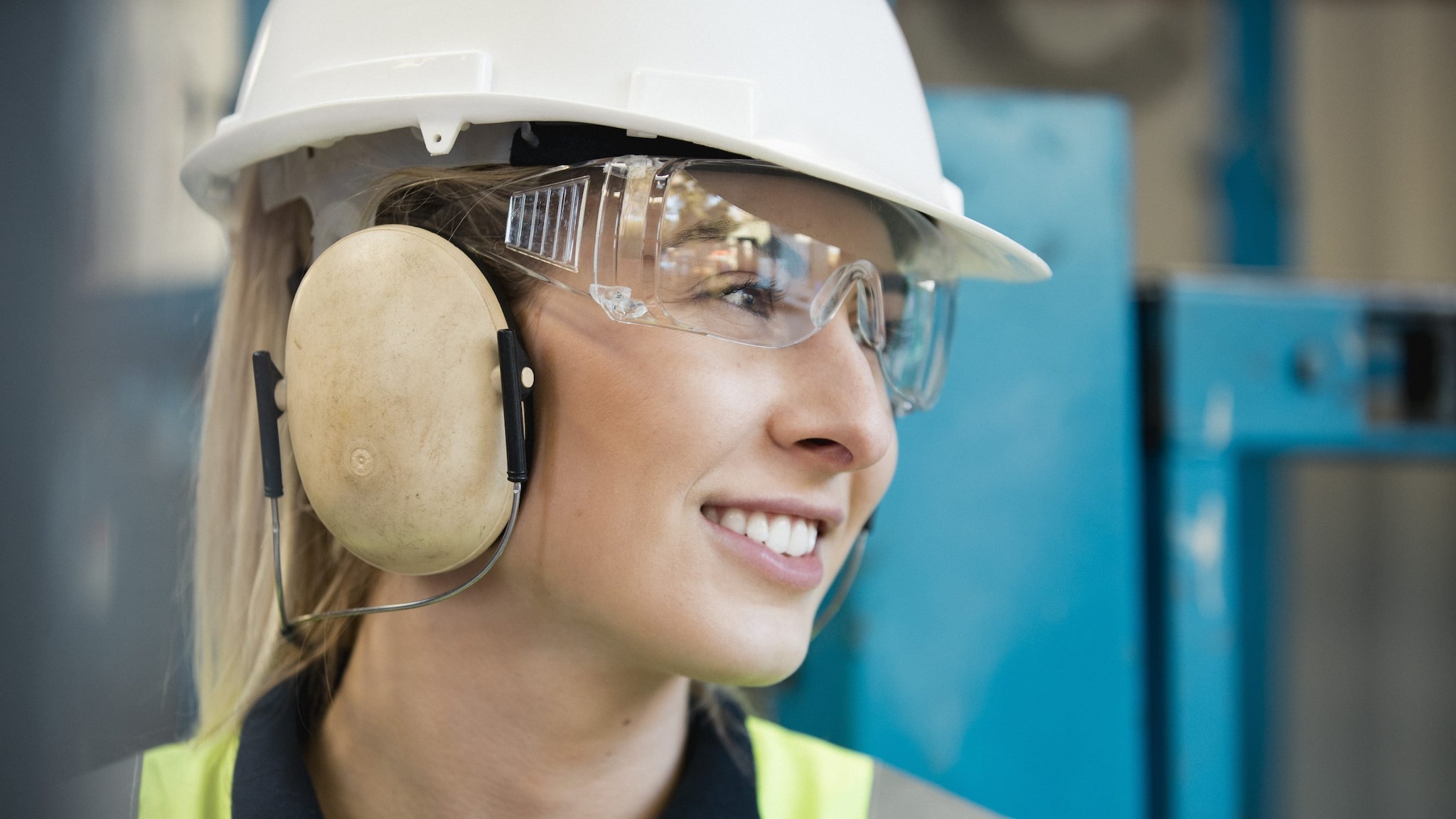 Worker wearing protective earmuffs