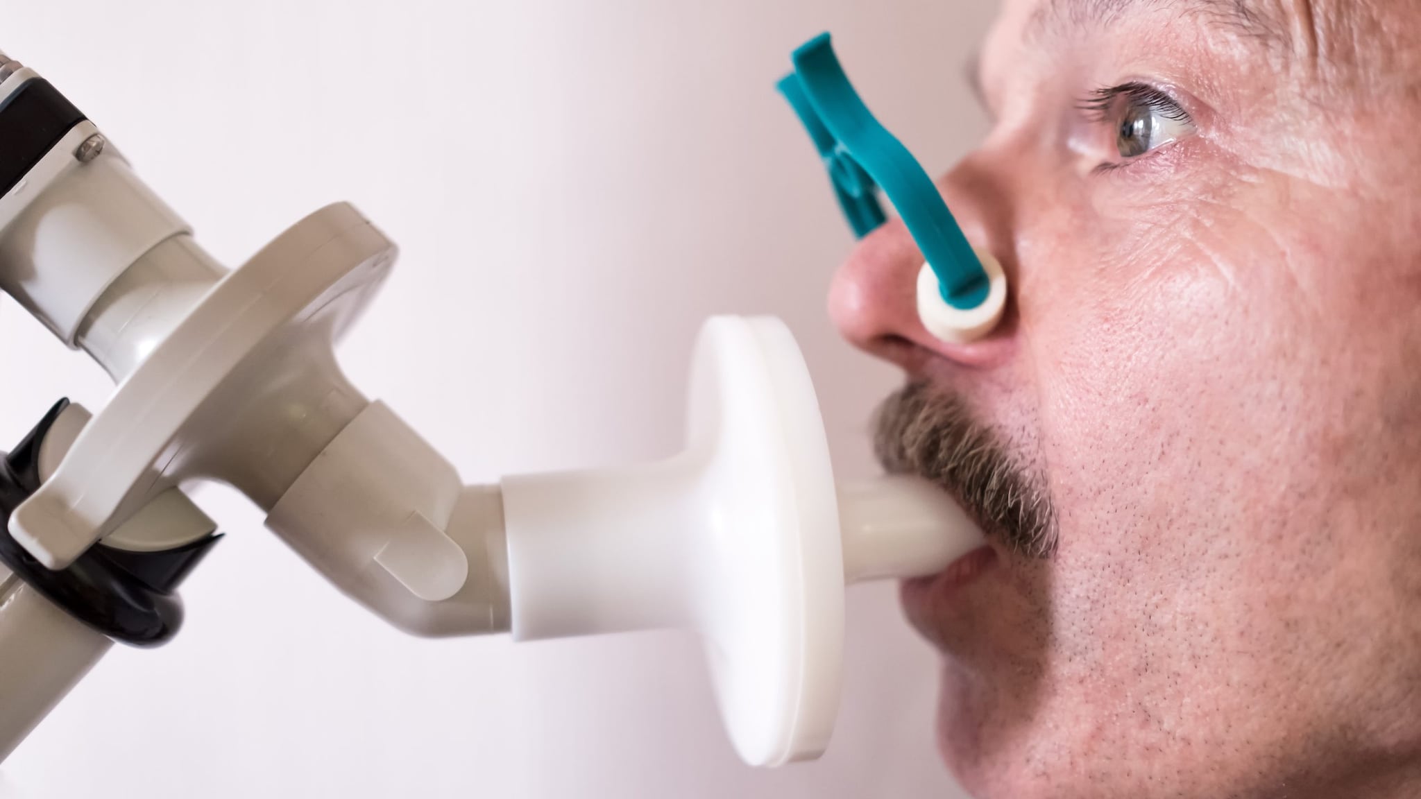 Close up of a male performing spirometry.