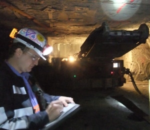 Jacob Carr performing research on a continuous mining machine in an underground coal mine