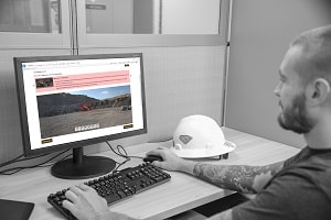 Photograph showing a user at a workstation searching for worksite hazards via the Hazard Recognition Challenge web application.
