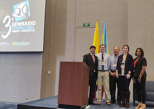 Five NIOSH Mining researchers stand on stage at the 3rd International Seminar for Mining and Energy in Colombia.