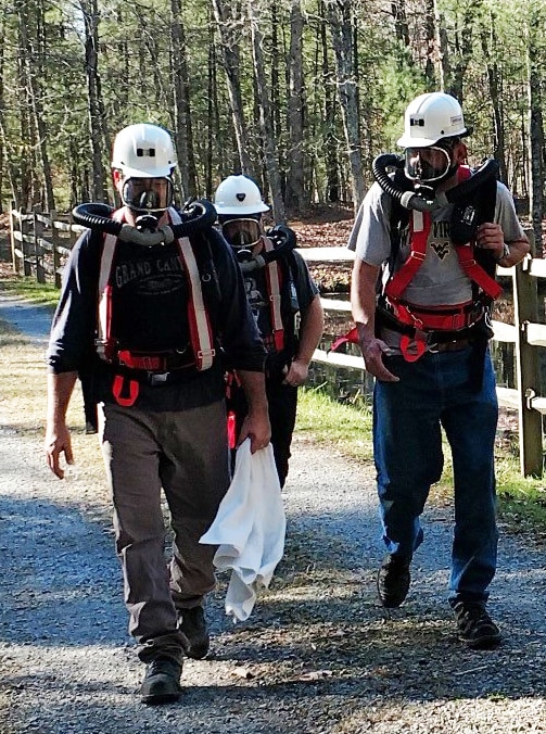 A photo of Steve Sawyer walking with colleagues during a training exercise