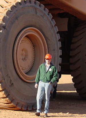 Todd Ruff next to a large tire