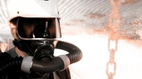 NIOSH researcher wearing a respirator in a virtual reality mine fire simulation