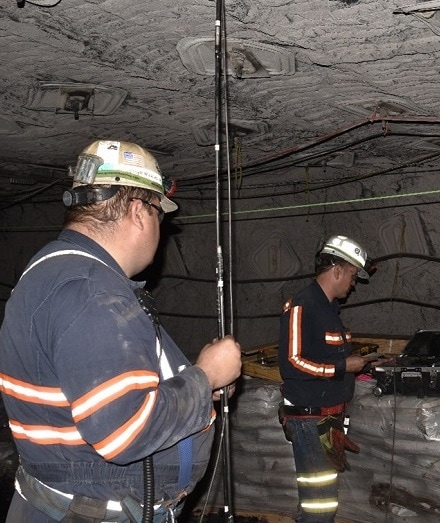 NIOSH employees operating a high-definition borescope to record the lithology in the mine roof prior to installing a roof extensometer.