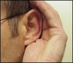 Hand cupping ear to hear better