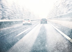 Snowy dangerous car overtaking on highway