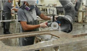 A countertop fabricator grinding a stone countertop.  Photo by NIOSH