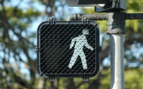 crosswalk sign showing figure for walk