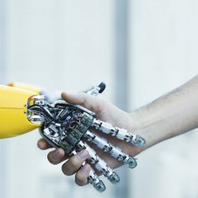 human hand shaking a robot hand