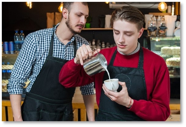 a young worker training to become a barista