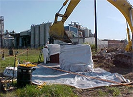 Workers cleaning up residual contamination from an area that had become contaminated from early nuclear weapons production programs (Courtesy of US Army Corps of Engineers)