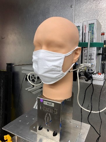 Photo of a mannequin wearing a mask, demonstrating lab simulations on mask effectiveness