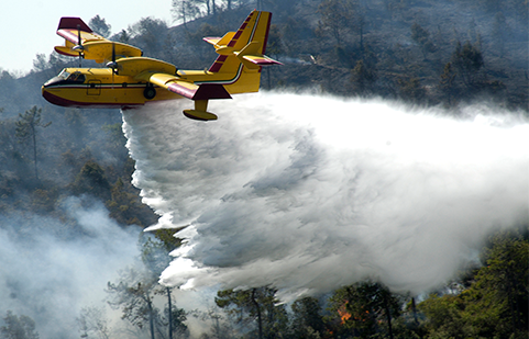 Airtanker aircraft drops retardant on wildfire in California. 