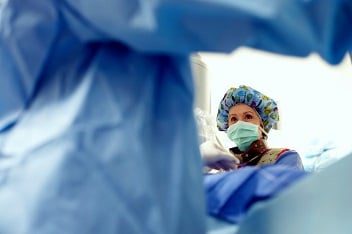 nurse looking up during surgery