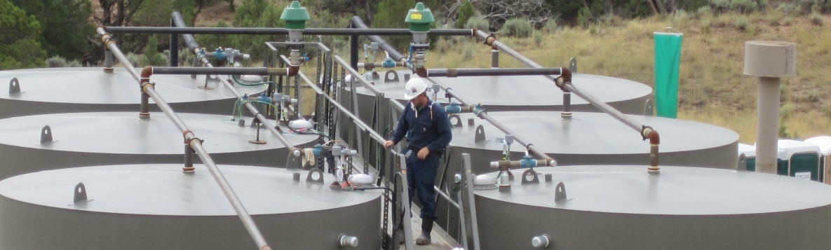 Worker preparing to gauge oil production tanks. Photo credit: NIOSH Western States Division