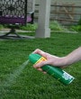 Personal insect repellant being sprayed outside