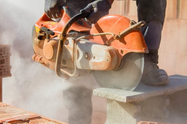 Image of construction worker grinding cement