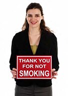 woman holding a sign says thank you for not smoking