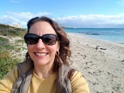 a woman on the beach wearing sunglasses