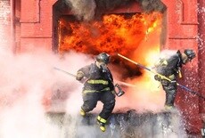 Two firefighters putting out a fire