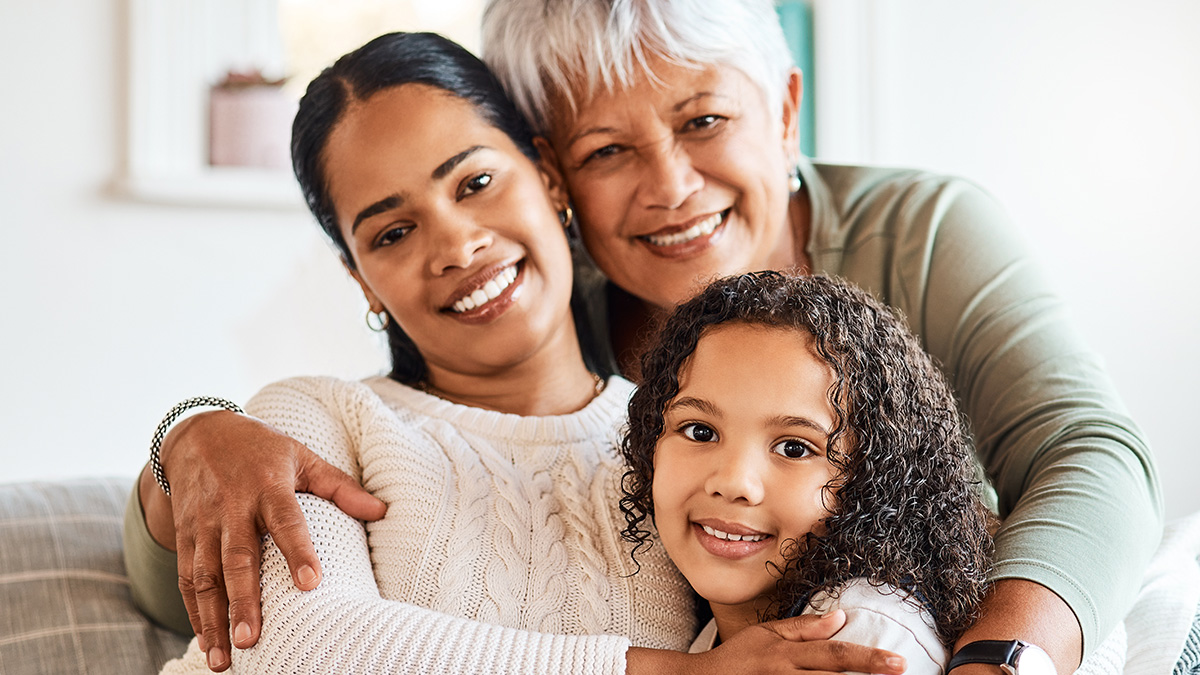 A grandmother spends time with her daughter and grandchild at home