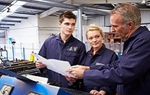 Three workers consulting on LOTO training