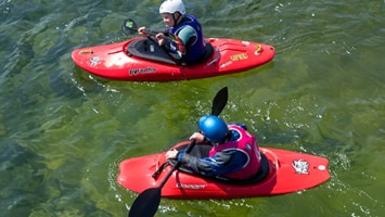 Two kayakers paddling in the water